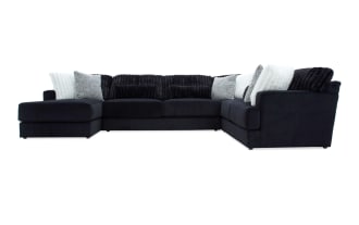 Sofia Black 159" 4-piece left arm facing chaise sectional in black polyester fabric with channel tufted cushions and nine faux fur pillows, transitional style.