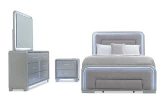 Shimmer 4 Piece Full Silver Storage Panel Bedroom Set with glam silver MDF frame, gray polyester fabric upholstery, LED lighting, USB ports, felt- and cedar-lined drawers, and a footboard storage drawer.