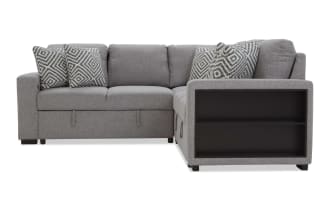 Gray fabric sectional sofa with black wooden side shelves, featuring six geometric patterned throw pillows, designed for modern living rooms.
