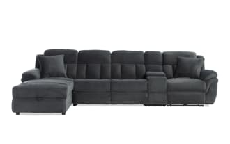 Dark gray fabric sectional sofa with chaise lounge, plush cushioning, padded armrests, and two matching throw pillows, modern style.