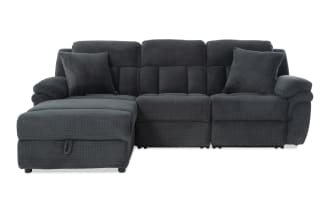 Dark gray fabric sectional sofa with plush cushions, padded armrests, and two matching throw pillows, featuring a chaise lounge on the left side.