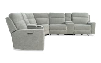 Gray fabric sectional recliner sofa with padded armrests, cup holders, and adjustable headrests, designed for modern living rooms.