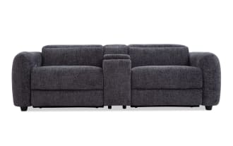 Dark gray fabric reclining loveseat with plush cushions, wide armrests, and a central console for storage or cup holders, modern style.