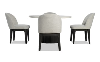 Delaney 5 Piece Black & White Marble Dining Set with round genuine marble tabletop, light gray polyester upholstered chairs, and black rubberwood legs in contemporary style.