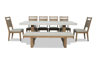Monterey 8 Piece Natural & Gray Panel Back Upholstered Dining Set with bench, gray polyester fabric, faux concrete melamine tabletop, traditional style.