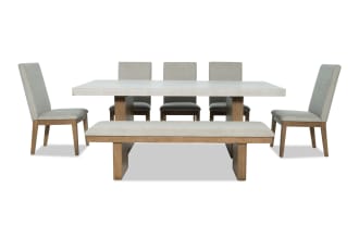 Monterey 7 Piece Natural & Gray Solid Back Upholstered Dining Set with Bench, traditional style with gray polyester fabric, faux concrete melamine table top, rubberwood and hardwood solids frame, includes five memory foam chairs and matching bench.
