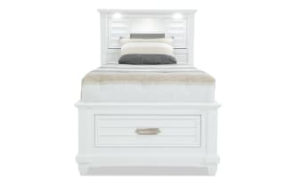 Sunset Cove Youth Twin White Bookcase Storage Bed in coastal style with MDF frame, built-in drawers, LED lighting, power outlets, and USB ports.