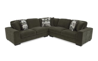 Dark olive green fabric sectional sofa with tufted armrests, plush cushions, and patterned accent pillows, designed for modern living rooms.