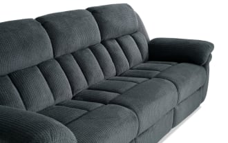Dark gray fabric reclining sofa and loveseat set with plush padded armrests and backrests, featuring a textured upholstery and manual recline controls.