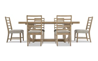 Dining set with a rectangular wooden table and six matching ladder-back chairs with beige upholstered seats, featuring a natural oak finish.