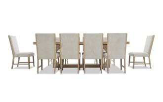 Dining set with a large rectangular wooden table and ten beige upholstered chairs featuring wooden legs and high backs, suitable for modern dining rooms.