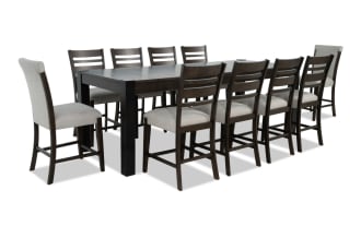 Aurora 11-piece transitional dining set in gray fabric polyester upholstery with brown rubberwood frame, extendable 86"-102" table, and storage compartments.