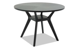 Black wooden round table with angled legs and a modern minimalist design, suitable for dining or office use.