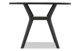 Black wooden round table with angled legs and a modern minimalist design, suitable for dining or office use.