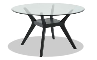 Modern round glass dining table with black wooden angled legs and central support beam, showcasing contemporary minimalist design.