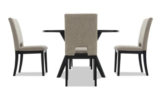 Dining set with a black rectangular table and three beige upholstered chairs featuring wooden legs, suitable for modern dining rooms.
