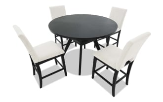 Dining set with a black rectangular table and four cushioned chairs featuring beige fabric upholstery and black wooden legs, modern style.