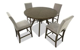 Dining set with three beige upholstered fabric chairs featuring wooden legs and a matching round wooden table, ideal for modern home decor.