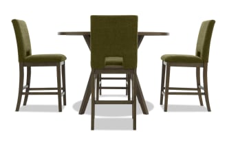 Dining set with a round wooden table and four olive green upholstered chairs featuring dark wood legs and footrests, modern style.