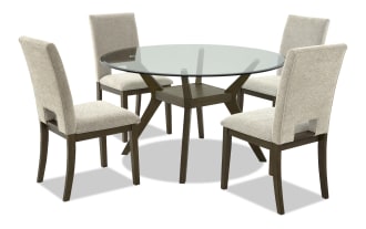 Round dining table set with a glass top and dark wood base, paired with four beige upholstered chairs with wooden legs, modern style.