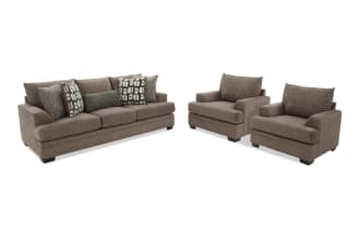 Brown fabric living room set including a three-seat sofa and two armchairs with patterned and solid accent pillows, featuring dark wooden legs and plush cushions.