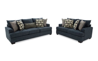 Dark blue fabric sofa with three seat cushions and multiple patterned throw pillows, shown from front and side angles, highlighting its modern design and plush comfort.