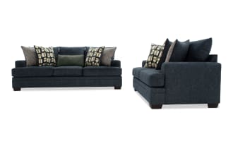 Dark blue fabric sofa with three seat cushions and multiple patterned throw pillows, shown from front and side angles, highlighting its modern design and plush comfort.