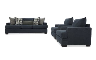 Dark blue fabric living room set featuring a three-seat sofa with patterned and solid throw pillows, and two matching armchairs with plush cushions and wooden legs.