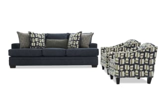 Dark blue fabric sofa with six patterned and textured throw pillows, paired with two matching armchairs featuring geometric multicolor upholstery and dark wooden legs.