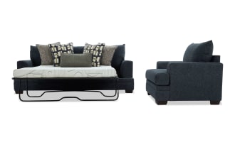Dark blue fabric sleeper sofa with geometric and textured throw pillows, metal frame mattress support, and wooden legs, shown from front and side.