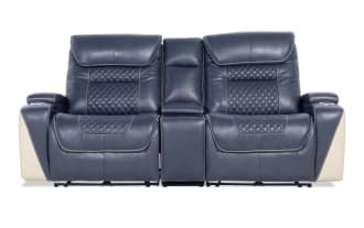 Blue leather reclining loveseat with diamond-stitched backrests, cream side panels, cup holders, and center console for home theater seating.