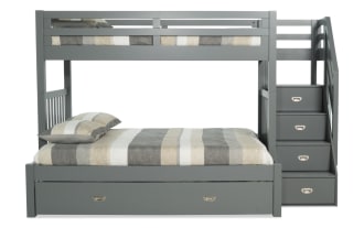 Chadwick Twin/Full gray stairway bunk bed with twin trundle, pine solids, transitional style, featuring side stairs with built-in storage drawers and striped bedding.