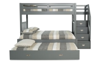 Chadwick Twin/Full gray stairway bunk bed with twin trundle, pine solids, transitional style, featuring side stairs with built-in storage drawers and striped bedding.