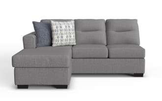 Dylan Slate left-arm facing sleeper sofa and chaise kit in gray polyester fabric, transitional style with plush cushions and two decorative pillows.
