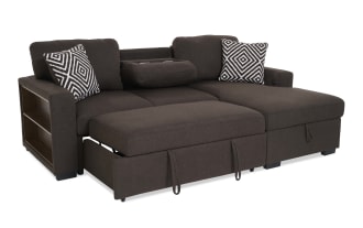 Brown fabric sectional sofa with chaise lounge, featuring two black and white geometric patterned throw pillows, modern design.