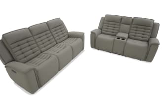 Modern gray leather reclining three-seater sofa with plush tufted cushions and padded armrests, shown from front and side views.