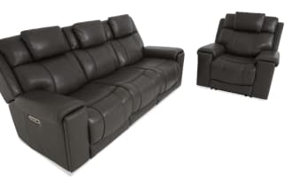 Dark gray leather reclining sofa set with three seats, padded headrests, and cushioned armrests, shown from front and side angles.