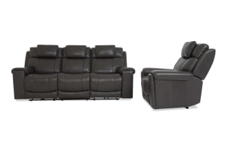 Dark gray leather reclining sofa set with three seats, padded headrests, and cushioned armrests, shown from front and side angles.