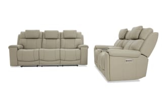 Beige leather reclining sofa set with three seats, padded armrests, adjustable headrests, and built-in control panel for comfort and style.