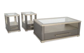 Modern gray and beige lacquered wood coffee table and matching end tables set, featuring metallic handles and a sleek, contemporary design.