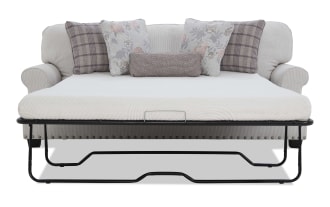 Light gray fabric sofa bed with black metal frame, white mattress, and decorative pillows in floral and plaid patterns, ideal for small spaces.