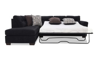 Black sectional sleeper sofa with tufted back cushions, metal frame pull-out bed, and patterned accent pillows, ideal for small spaces.
