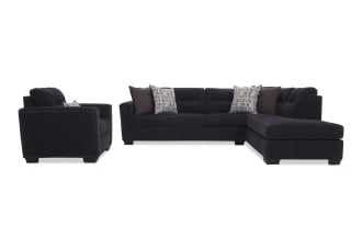 Dark gray fabric sectional sofa with chaise and matching armchair, featuring plush cushions and decorative throw pillows, modern living room furniture.