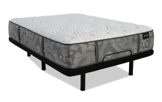 Zinus mattress with gray patterned fabric and white quilted top, supported by a black metal bed frame with legs and a center support bar.