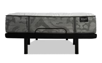 Zinus mattress with gray patterned fabric and white quilted top, supported by a black metal bed frame with legs and a center support bar.