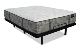 Zeus brand mattress with gray patterned fabric and white quilted top on a black metal bed frame with six legs and a center support bar.