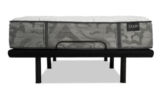 Zeus brand mattress with gray patterned fabric and white quilted top on a black metal bed frame with six legs and a center support bar.