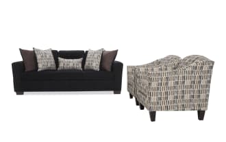 Dark fabric sofa with plush cushions and two patterned armchairs featuring a modern geometric design, ideal for contemporary living rooms.
