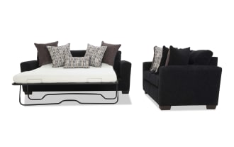 Black fabric sleeper sofa bed with metal frame mattress support, featuring multiple patterned and solid throw pillows, shown in open bed and closed sofa views.