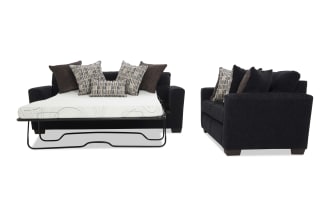 Black fabric sofa bed with a fold-out metal frame mattress, featuring multiple patterned and solid throw pillows, showcasing versatile living room furniture.